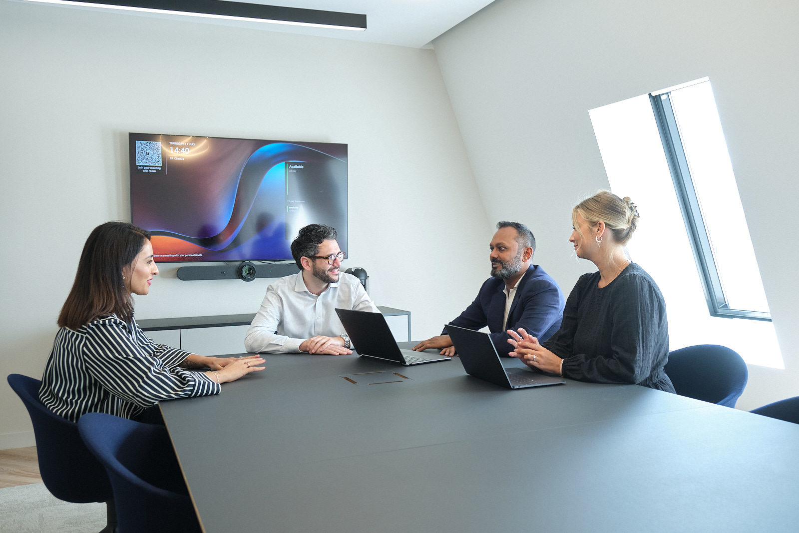 Four Privalgo employees in the Privalgo office meeting room